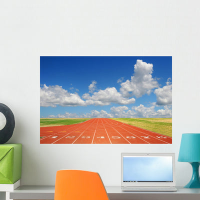 Running Track with Clouds Wall Mural shown on a wall