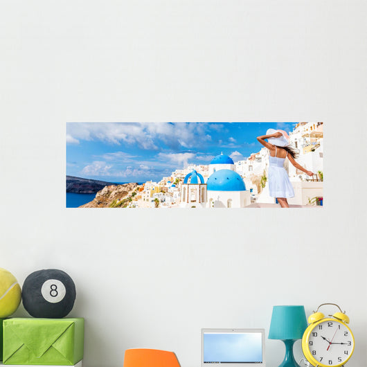 Europe tourist travel woman panorama banner from Oia, Santorini, Greece. Happy young woman looking at famous blue dome church landmark destination. Beautiful girl visiting the Greek islands. Wall Mural