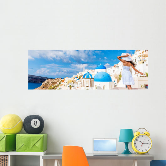 Europe tourist travel woman panorama banner from Oia, Santorini, Greece. Happy young woman looking at famous blue dome church landmark destination. Beautiful girl visiting the Greek islands. Wall Mural