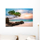Exotic seascape with sea grape trees leaning above a rocky Caribbean beach at sunset, in Cayo Levantado, Dominican Republic Wall Mural