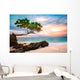 Exotic seascape with sea grape trees leaning above a rocky Caribbean beach at sunset, in Cayo Levantado, Dominican Republic Wall Mural