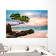 Exotic seascape with sea grape trees leaning above a rocky Caribbean beach at sunset, in Cayo Levantado, Dominican Republic Wall Mural