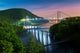 Hudson River valley with Bear Mountain bridge illuminated by night, in New York state Wall Mural