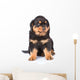 Small rottweiler puppy sitting. Isolated on white background Wall Decal
