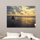 a surfer in bali beach walking toward the sunset Wall Mural