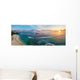 Panoramic view of tropical beach with surfers at sunset. Wall Mural