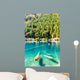 Fantastic azure water of lake with submerged tree trunks Wall Mural
