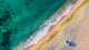 Aerial view of ocean waves and sand on beach Wall Mural