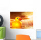 Rubber duckling in evening sunshine on the sea Wall Mural