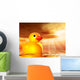 Rubber duckling in evening sunshine on the sea Wall Mural