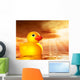 Rubber duckling in evening sunshine on the sea Wall Mural
