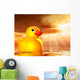 Rubber duckling in evening sunshine on the sea Wall Mural