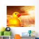 Rubber duckling in evening sunshine on the sea Wall Mural