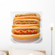 three classic hotdogs with mustard and ketchup on a plate Wall Mural
