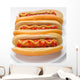 three classic hotdogs with mustard and ketchup on a plate Wall Mural