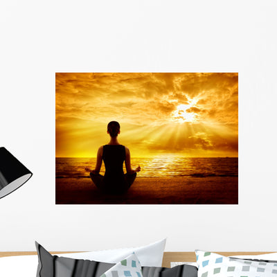 Yoga Meditating Sunrise Woman Wall Mural shown on a wall