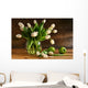 White tulips in glass vase on rustic wood Wall Mural
