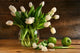 White tulips in glass vase on rustic wood Wall Mural