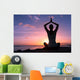 Young healthy woman practicing yoga on the beach at sunset

 Wall Mural