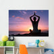Young healthy woman practicing yoga on the beach at sunset

 Wall Mural