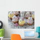 Purple and yellow cupcakes with sugared edible flowers on vintage cake stand Wall Mural