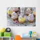 Purple and yellow cupcakes with sugared edible flowers on vintage cake stand Wall Mural