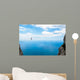 Man climbing on the suspension bridge. Wall Mural