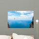 Man climbing on the suspension bridge. Wall Mural