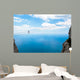 Man climbing on the suspension bridge. Wall Mural
