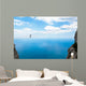 Man climbing on the suspension bridge. Wall Mural