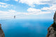 Man climbing on the suspension bridge. Wall Mural