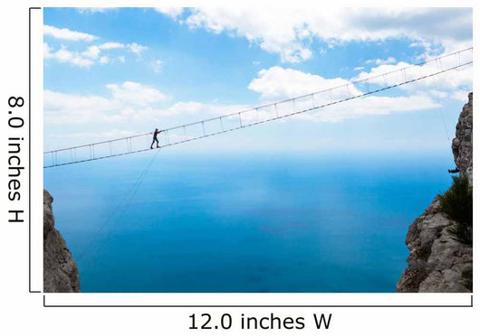Man climbing on the suspension bridge. Wall Mural