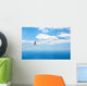 Man climbing on the suspension bridge. Wall Mural