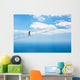 Man climbing on the suspension bridge. Wall Mural