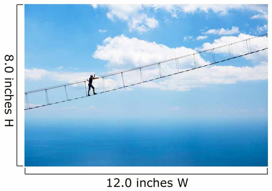 Man climbing on the suspension bridge. Wall Mural