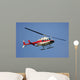 helicopter flying against a deep blue sky Wall Mural