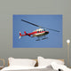 helicopter flying against a deep blue sky Wall Mural