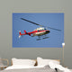 helicopter flying against a deep blue sky Wall Mural