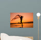 Silhouette of girl running on the beach Wall Mural