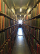A man studying inside a library in England Wall Mural