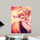 Funny woman holds cake in hand covering her eye Wall Mural