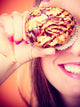 Funny woman holds cake in hand covering her eye Wall Mural