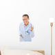 A young dentist with a tool on a white background Wall Decal