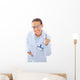 A young dentist with a tool on a white background Wall Decal