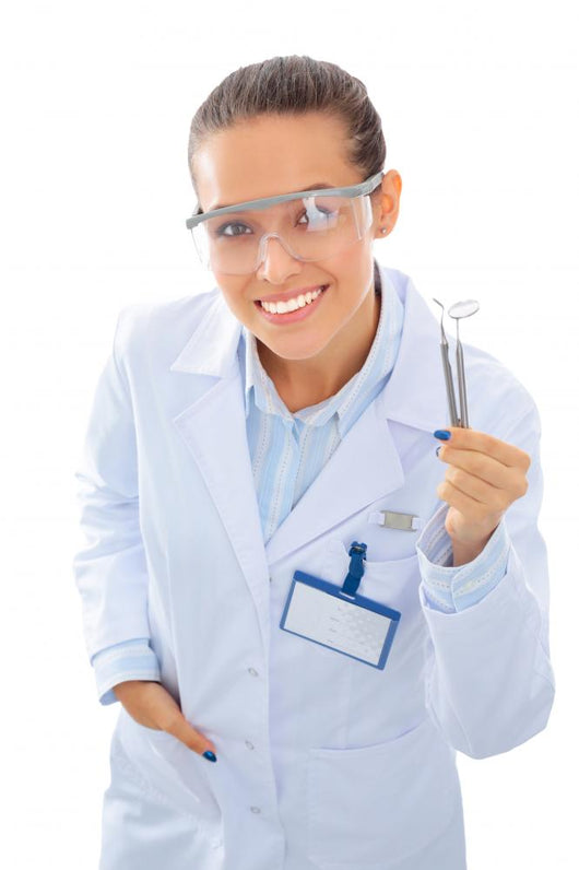 A young dentist with a tool on a white background Wall Decal