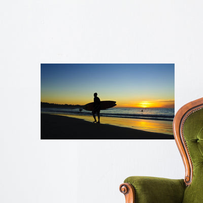Surfer Sunset Wall Mural shown on a wall