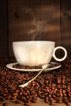 White coffee cup with spoon on roasted beans Wall Mural
