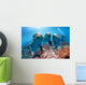 three dolphins close up portrait underwater while looking at you Wall Mural