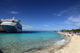 Cruise ship docked in tropical island beach port Wall Mural