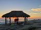 Silhouette of women under a beach shack in La Jolla, California.  Wall Mural